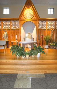 A replacement altar stands in the sanctuary of Annunciation of the Lord Catholic Church in Decatur on Sunday night. The altar replaces a century-old marble altar that a man pushed over during Sunday s 11 a.m. Mass. The marble altar tumbled down the steps and smashed onto the floor, damaging a portion of the carpet, foreground.