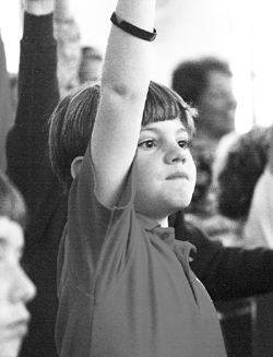 St. Ann third-grader Luke Denton appears eager to answer a question posed by Bishop David Foley.